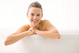 Portrait of smiling young woman in bathtub
