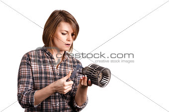 The girl mechanic with a caliper measures a car detail