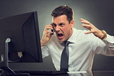Angry businessman shouting on phone