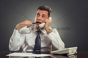 Thoughtful businessman on phone