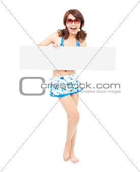 full length of sunshine girl standing and holding a board 