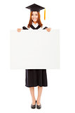 happy young female graduation students with blank board