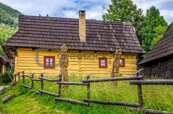 View of traditional village house and wooded statues
