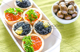 Tartlets with black and red caviar