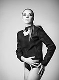 Studio fashion shot: pretty young woman wearing black jacket backwards