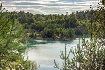 landscape of the forest blue lake on a quiet evening at sunset