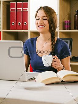 Student laughing in front of laptop