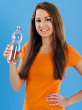 Happy young woman drinking bottled water