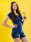 Happy young woman drinking beer
