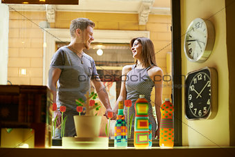Happy people with couple at window store and shopping