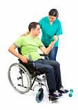 Physical therapist works with patient in lifting hands weights. 