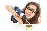 Funny geek girl trying to open a tin with a drill