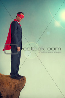 superhero businessman on a precipice