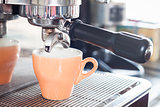 Orange coffe cup prepares for espresso