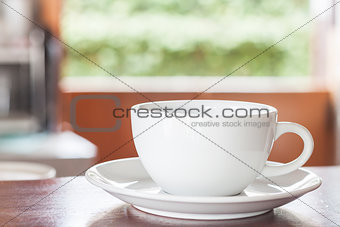 Cup of coffee on wooden counter