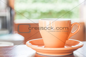 Still life with orange espresso coffee cup