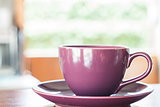 Purple coffee cup on wooden table