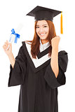 happy Graduate woman Holding diploma and thumb up