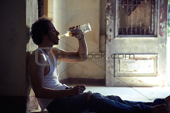 Portrait of drunk male alcoholist drinking whiskey