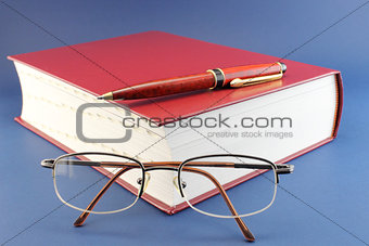 Book, pen and glasses