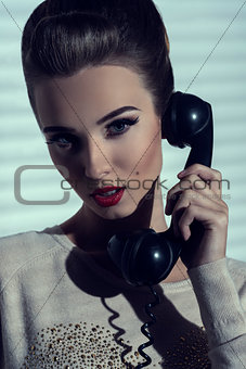 woman talking on vintage phone