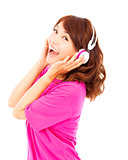 happy young girl listening and holding the earphone