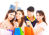 group of happy young people with shopping bags