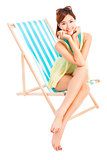 young woman smiling and sitting on a beach chair