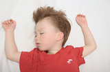 Boy sleeping arms outstretched