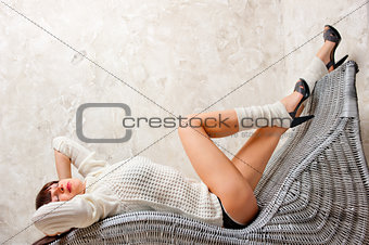 beautiful girl relaxes in a comfortable chair