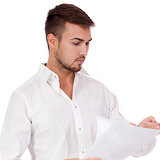 young adult businessman reading document letter isolated