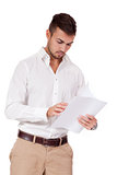 young adult businessman reading document letter isolated