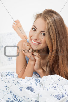 young brunette woman lying in bed sleeping morning 