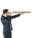 Businessman standing and looking through telescope