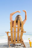 Pretty blonde sitting in deck chair with a cocktail