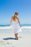 Pretty carefree blonde walking on the beach