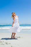 Pretty carefree blonde standing on the beach
