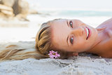 Pretty carefree blonde lying on the beach