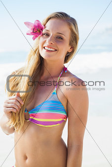 Gorgeous blonde in bikini smiling at camera