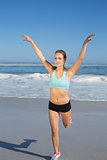 Fit woman stretching on the beach