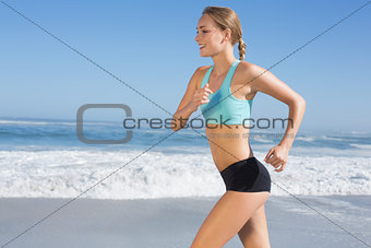 Fit woman jogging on the beach