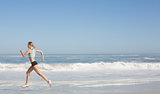 Fit woman jogging on the beach