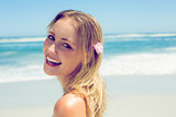 Beautiful blonde smiling at camera on the beach