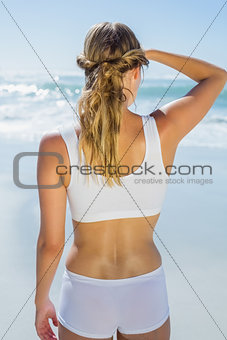 Gorgeous blonde standing by the sea looking out