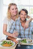 Cute smiling couple enjoying a meal together