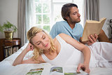 Couple relaxing on bed reading books