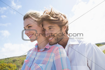 Smiling couple standing outside together