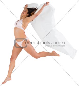 Beautiful brunette in white bikini holding towel