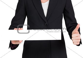 Businesswoman showing card and giving thumbs up