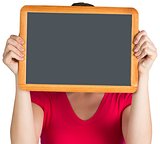 Woman holding chalkboard over face